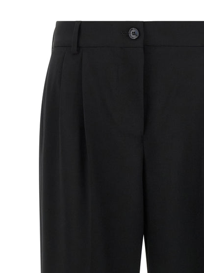 Trousers by Dolce & Gabbana for women in virgin wool black features a tailored silhouette with a tailored flared, defined by its long and a sophisticated mid rise.