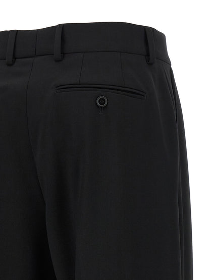 Trousers by Dolce & Gabbana for women in virgin wool black features an sartorial silhouette, showcasing a precise flared and long with a sartorial mid rise for a refined look.
