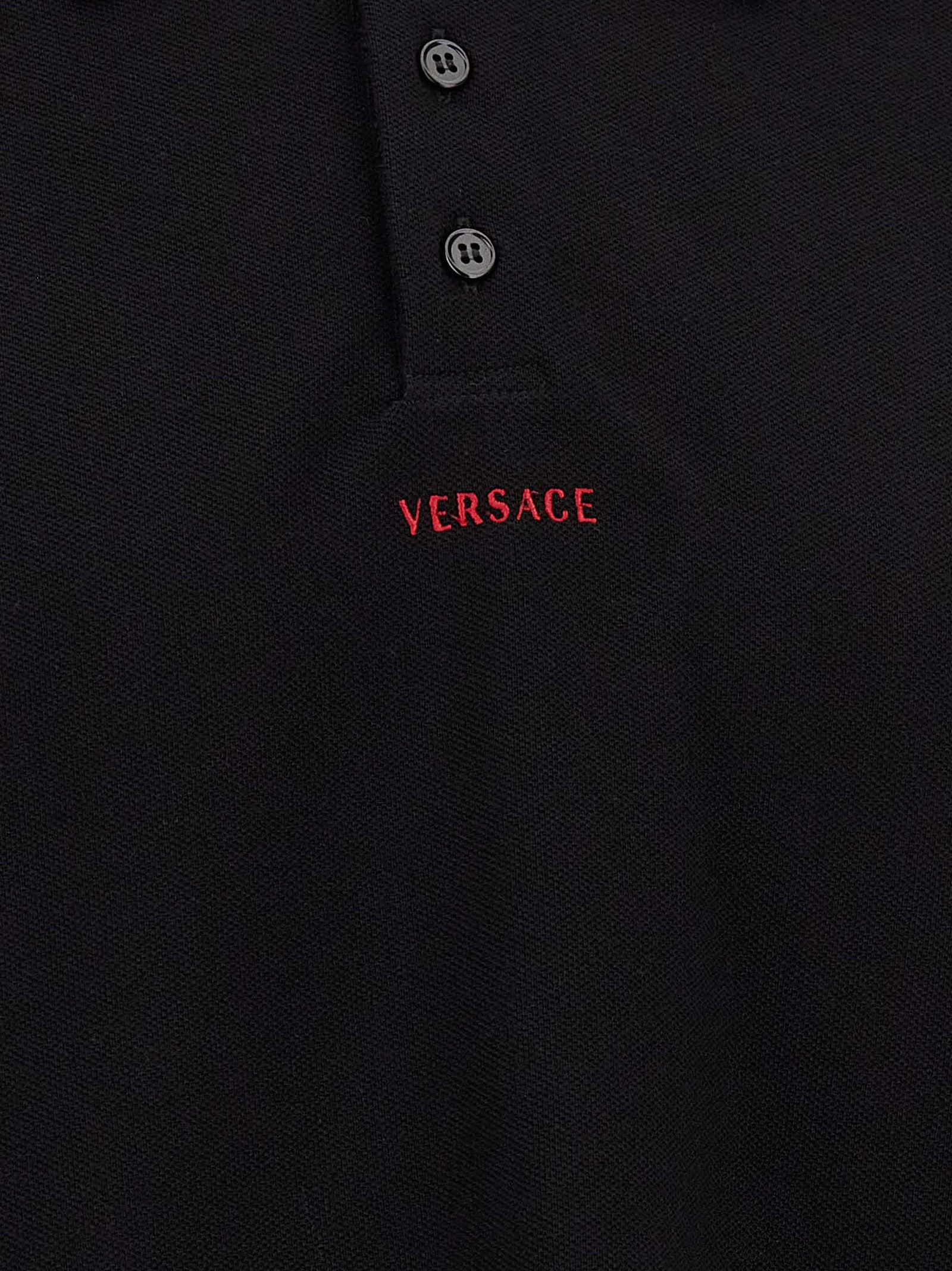 Polo Shirt by Versace for men in cotton black presents a distinguished silhouette, showcasing a sophisticated and distinguished for a truly distinguished finish.