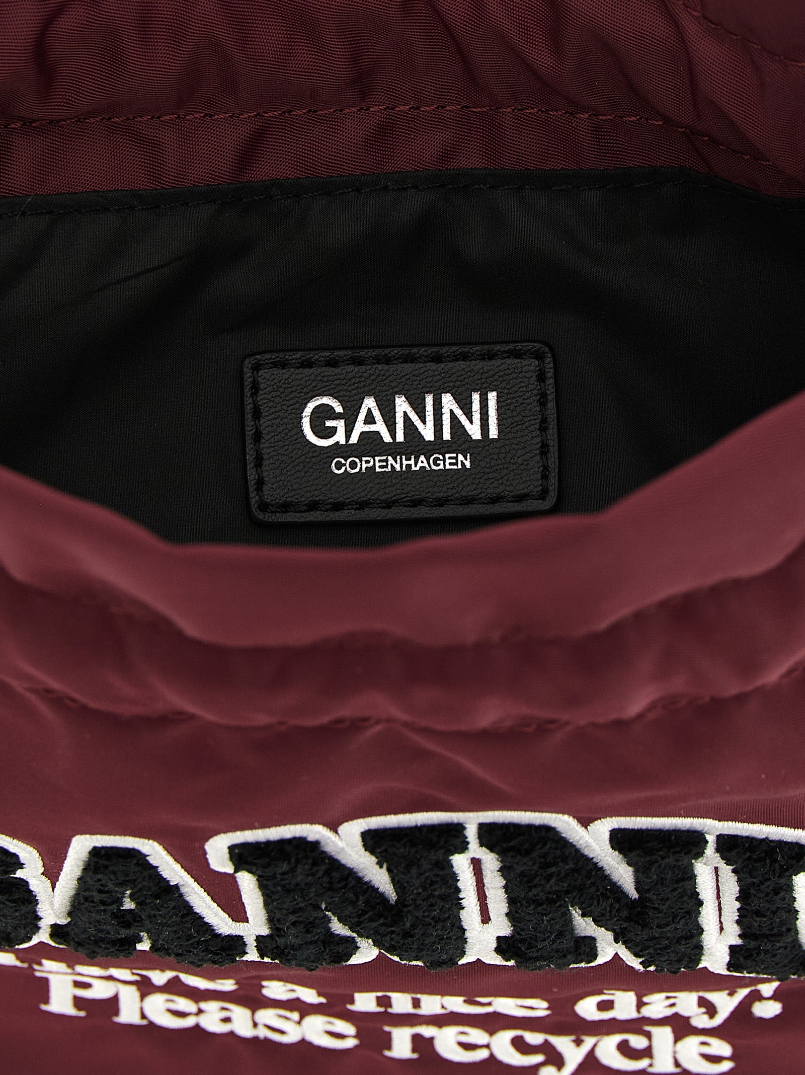 Bucket Pouch Clutch Handbag by Ganni for women in polyamide leather bordeaux & silver showcases a sculptural silhouette, featuring a secure , ample , and versatile for a sculptural finish.