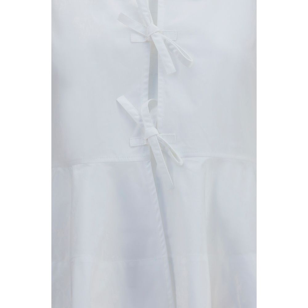 Blouse by Ganni for women in cotton white showcases a sleek silhouette, elegantly detailed with a sleek and for a sleek finish.