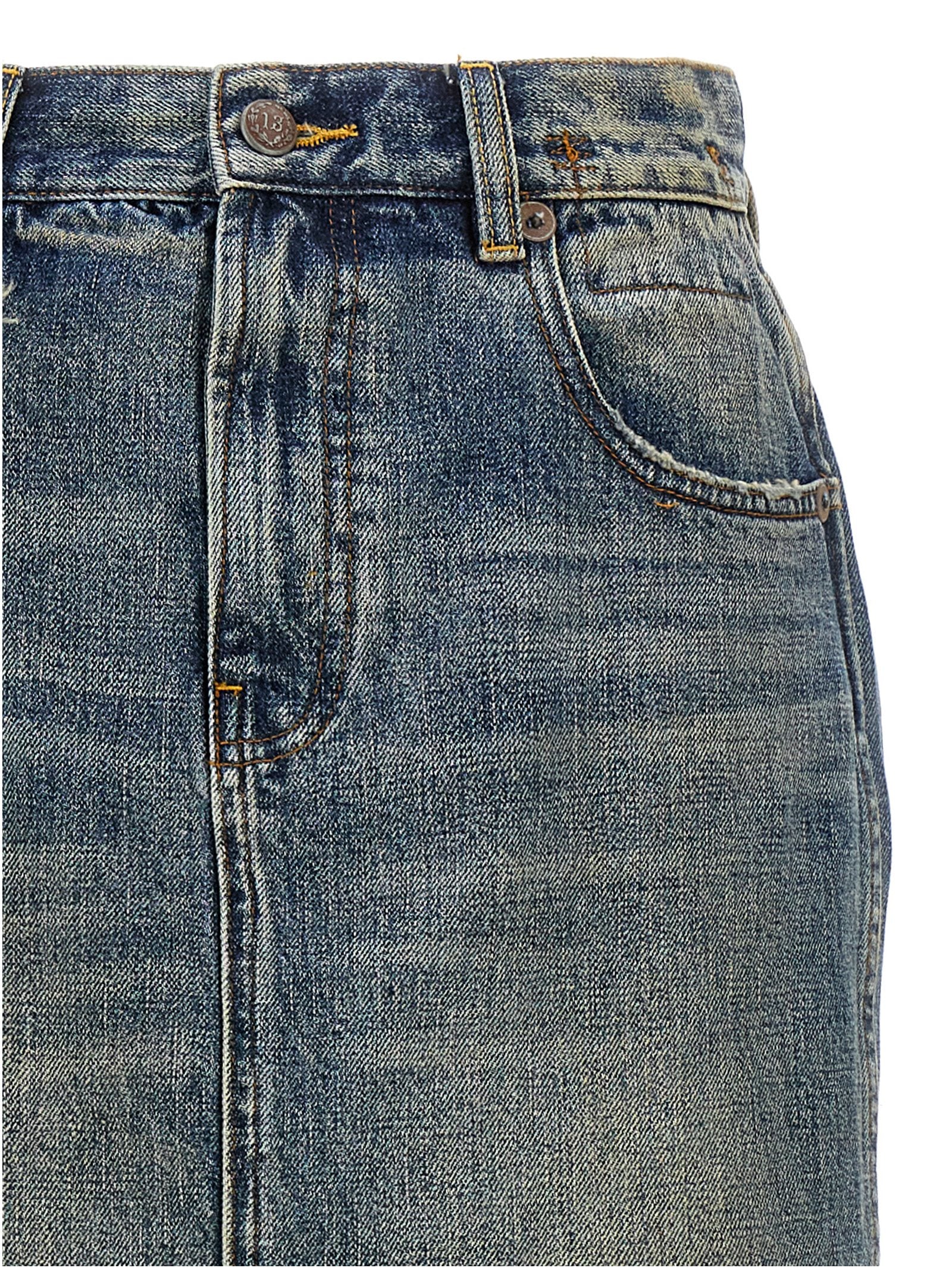 Skirt by R13 for women in cotton denim blue showcases a dramatic silhouette, artfully capturing the essence of the Devon Women's Denim Cotton Skirt in a dramatic mini cut for a refined look.