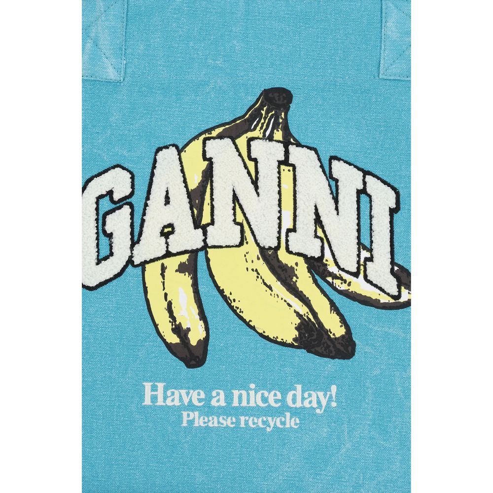 Medium Tote Shoulder Bag by Ganni for women in cotton blue, signature & print features an effortlessly chic silhouette with a secure zipper, ample single-compartment, and versatile handle for effortlessly chic everyday luxury.