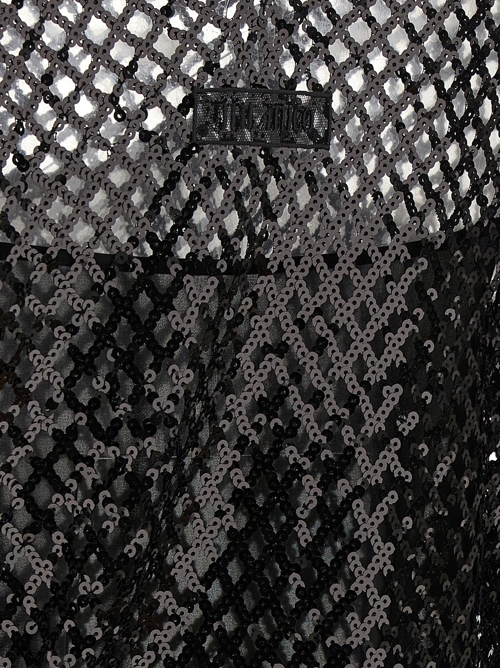 Dress by The Attico for women in polyester sequins black & transparent features an eye catching silhouette with a sophisticated , elegant , and a refined short mini for a eye catching aesthetic.