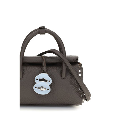Handbag by Zanellato for women in bos taurus calf leather brown presents a ornamental silhouette, showcasing a secure magnetic, buckle & roll-top, ample , and versatile shoulder-strap & adjustable-strap for a ornamental finish.