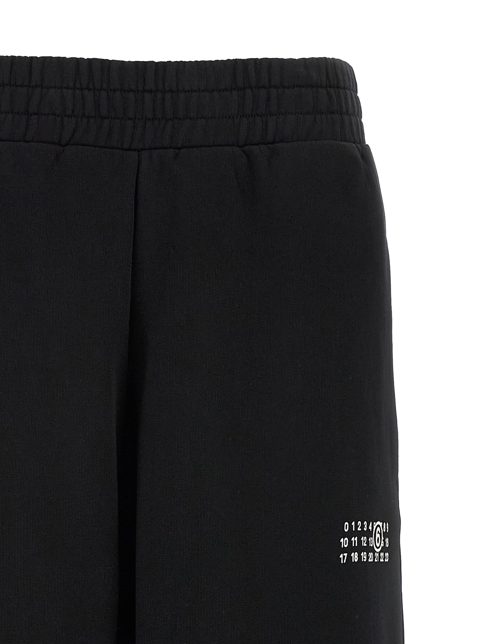 Joggers by MM6 Maison Margiela for women in cotton black, white, signature & print features an refined tailoring silhouette, showcasing a premium wide with a high rise and long cut for a refined tailoring look.