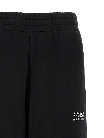 Joggers by MM6 Maison Margiela for women in cotton black, white, signature & print features an refined tailoring silhouette, showcasing a premium wide with a high rise and long cut for a refined tailoring look.