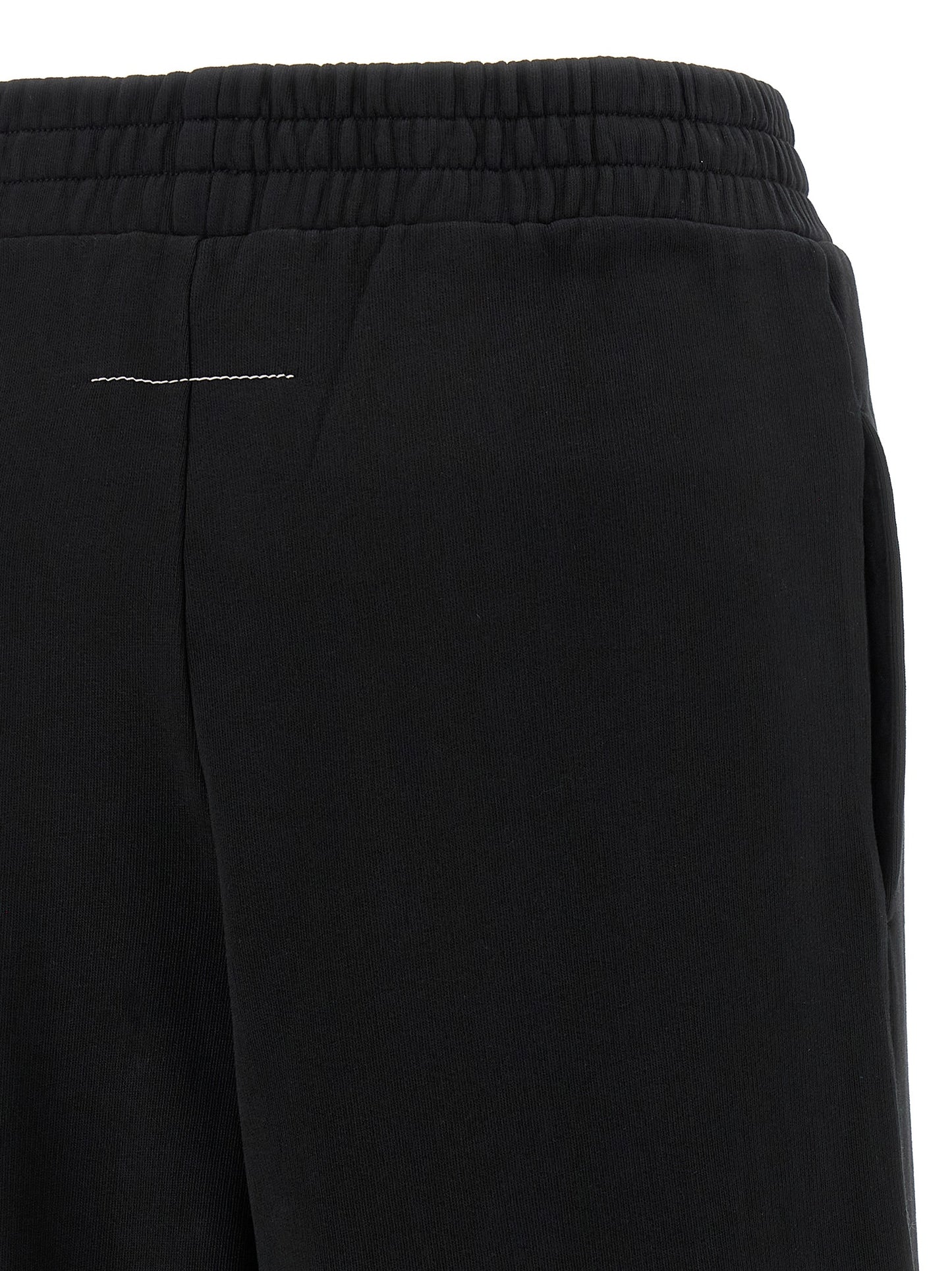 Joggers by MM6 Maison Margiela for women in cotton black, white, signature & print features an sartorial wide and long with a high rise cut for a sartorial finish.