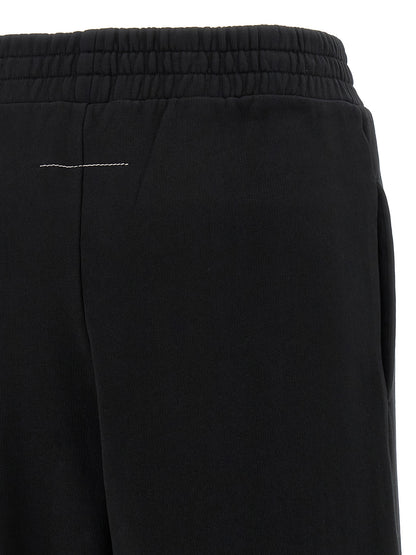 Joggers by MM6 Maison Margiela for women in cotton black, white, signature & print features an sartorial wide and long with a high rise cut for a sartorial finish.