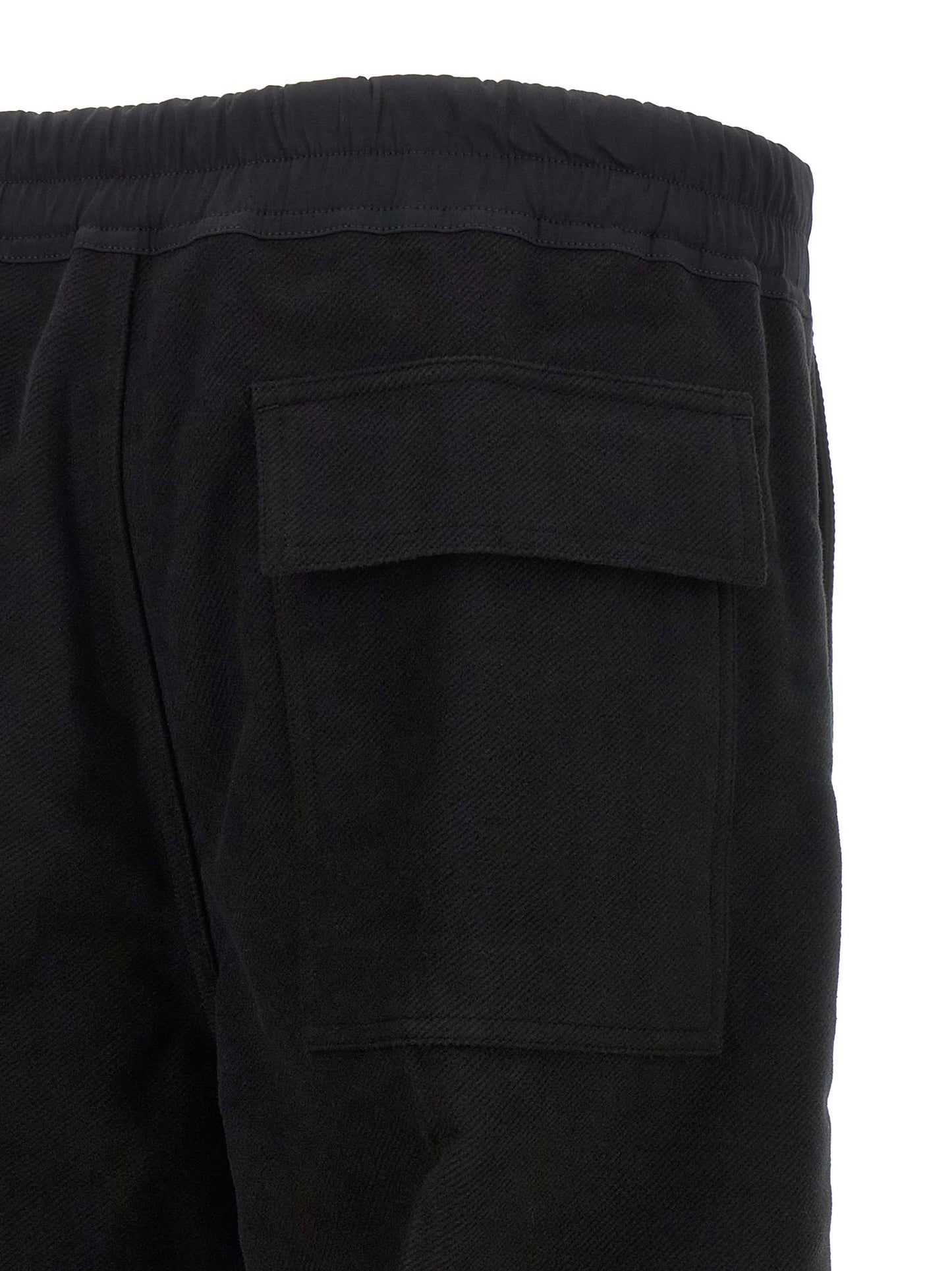 Trousers by Rick Owens for men in cotton black & herringbone presents a perennial silhouette, meticulously tailored with a straight-leg & wide cut, long finish, and an elegant .