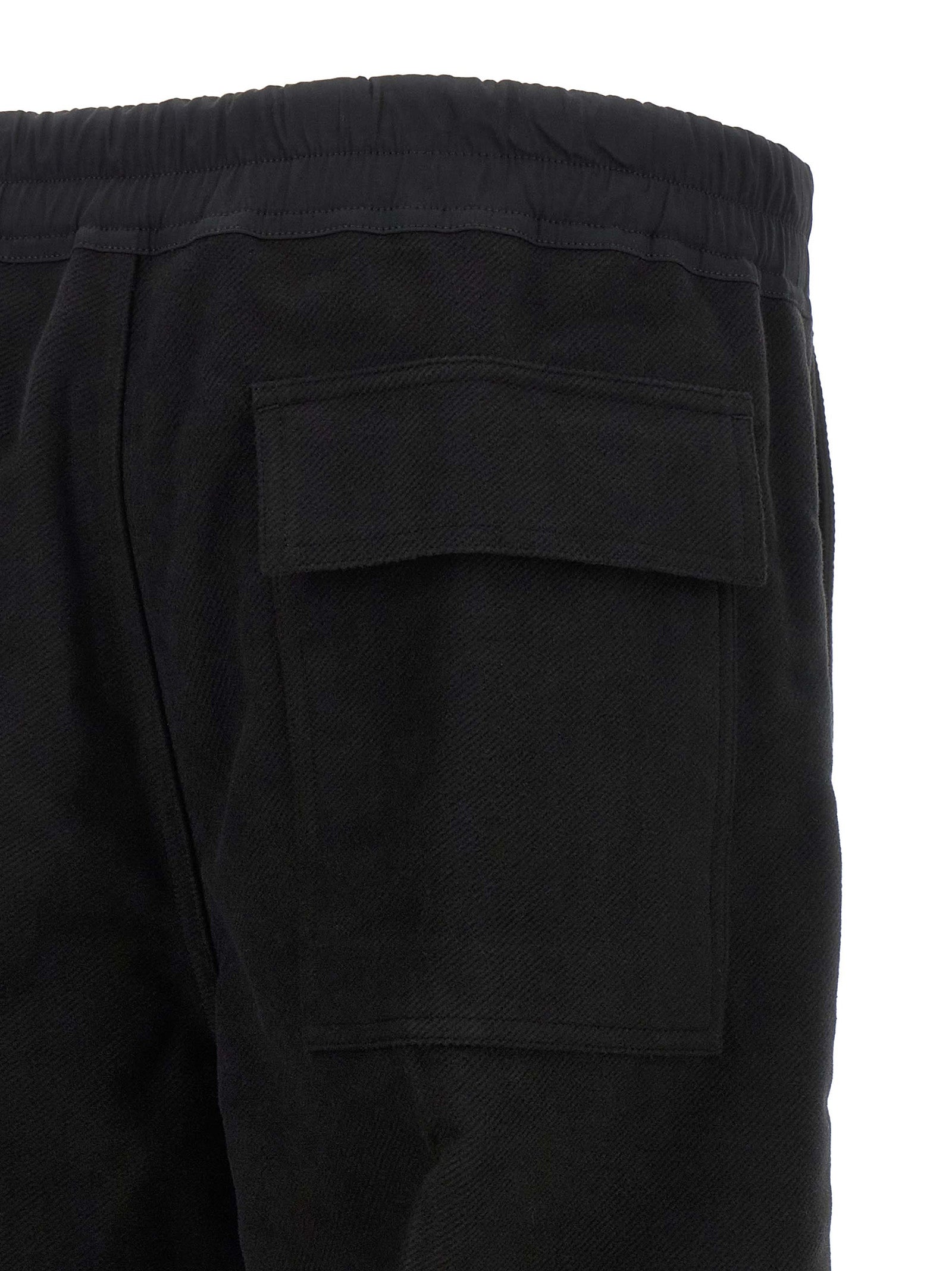 Trousers by Rick Owens for men in cotton black & herringbone presents a perennial silhouette, meticulously tailored with a straight-leg & wide cut, long finish, and an elegant .