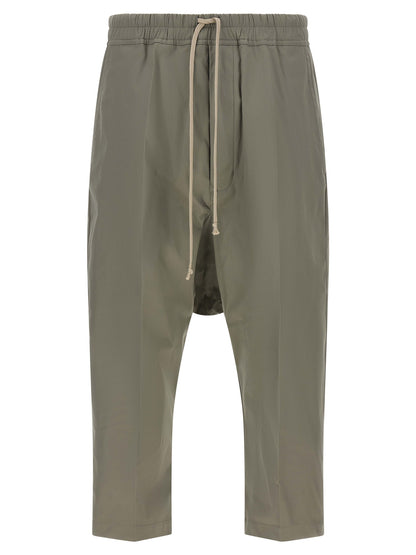 Trousers by Rick Owens for men in organic cotton gray presents a smart silhouette, meticulously detailed with a smart cropped, a smart cropped, and a smart .