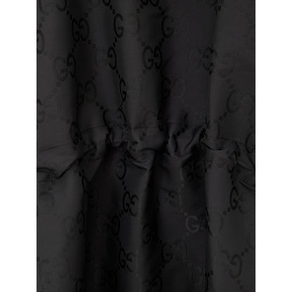Hooded Trench Coat by Gucci for men in polyamide & polyester black, monogram & print presents a utilitarian silhouette, showcasing a utilitarian hooded neckline and sophisticated hooded for a truly utilitarian look.