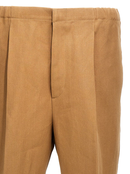 Trousers by Fendi for men in canvas beige features a sculptural silhouette, showcasing a sculptural and long with a sophisticated for a sculptural finish.