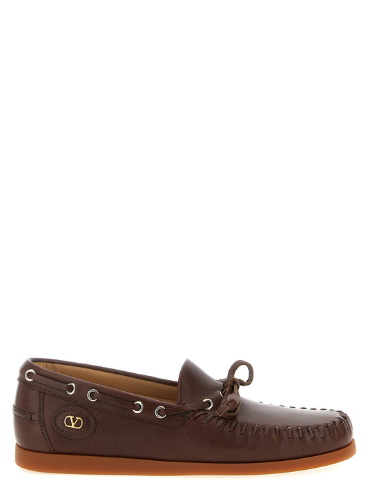 Boat Flat Shoes by Valentino Garavani for men in buffalo leather brown & signature features an statuesque silhouette from the V Logo Men's Buffalo Leather Boat Flat Shoes collection, showcasing a and a statuesque for a statuesque look.