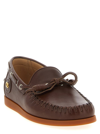 Boat Flat Shoes by Valentino Garavani for men in buffalo leather brown & signature presents a effortless chic silhouette, showcasing the V Logo Men's Buffalo Leather Boat Flat Shoes design with a effortless chic and for a sophisticated look.