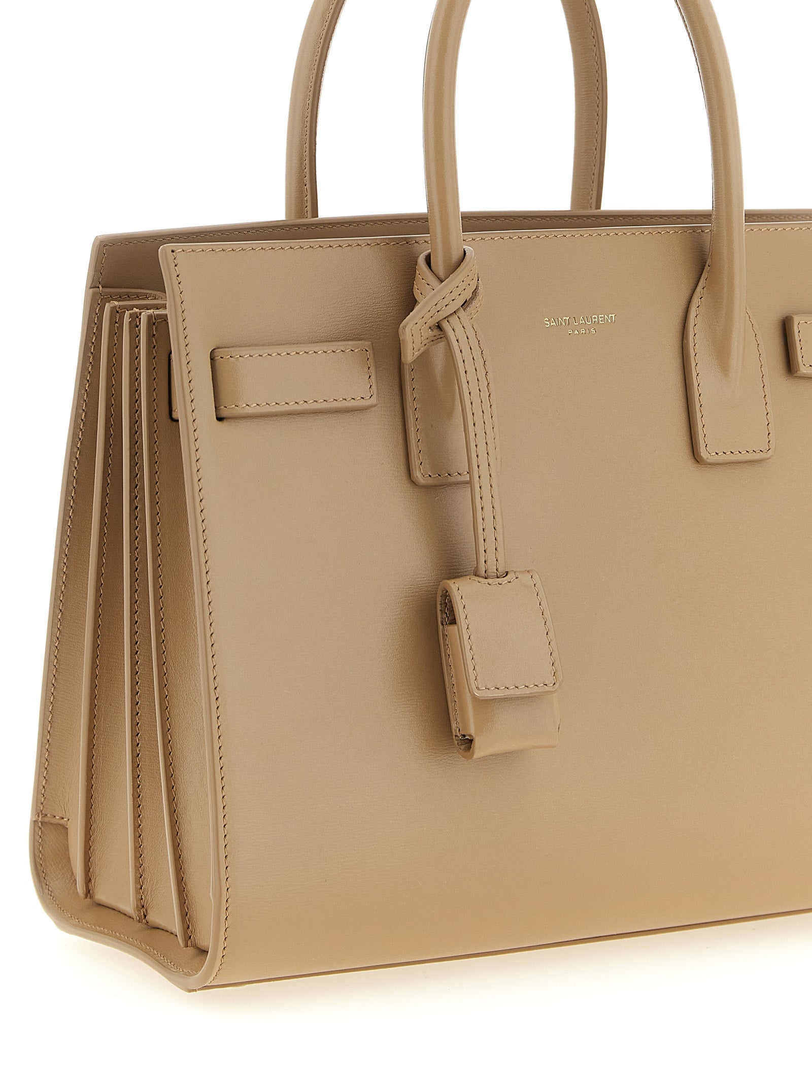 Handbag by Saint Laurent for women in calfskin leather beige features an refined silhouette, showcasing a secure , ample , and versatile shoulder-strap, handle & adjustable-strap for a sophisticated refined aesthetic.