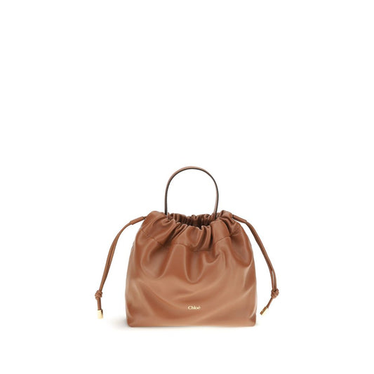 Mini Crossbody Drawstring Shoulder Bag by Chloé for women in nappa lambskin leather brown features a effortless sophistication silhouette, secured by a drawstring with ample and versatile crossbody-strap, shoulder-strap & handle for a effortless sophistication finish.