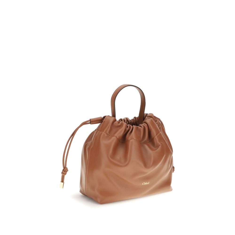 Mini Crossbody Drawstring Shoulder Bag by Chloé for women in nappa lambskin leather brown features an effortlessly chic silhouette with a secure drawstring, ample , and versatile crossbody-strap, shoulder-strap & handle for effortlessly chic everyday luxury.