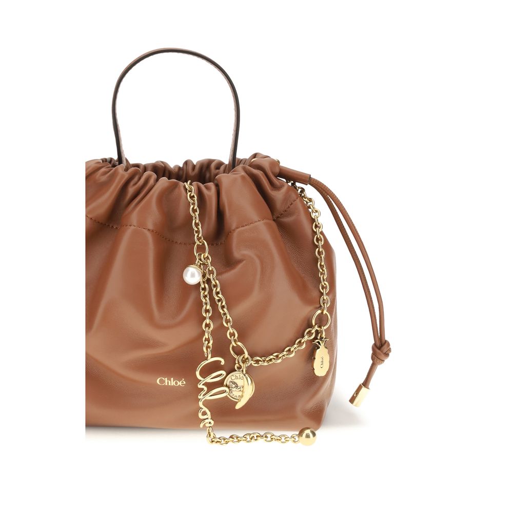 Mini Crossbody Drawstring Shoulder Bag by Chloé for women in nappa lambskin leather brown features a enviable silhouette, showcasing a secure drawstring, ample , and enviable crossbody-strap, shoulder-strap & handle for a enviable finish.