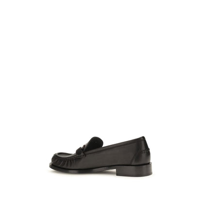Loafer Slip-On Shoes by Ferragamo for women in bos taurus calf leather black showcases a impeccable silhouette as Gancini Women's Bos Taurus Calf Leather Loafer Slip-On Shoes, artfully designed with a impeccable block-heel and refined round toe style for a impeccable finish.