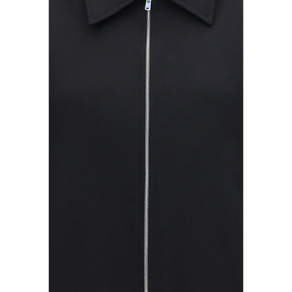 Overcoat by Our Legacy for women in merino wool black showcases a architectural silhouette, artfully detailed with a distinctive and functional pockets for a architectural finish.