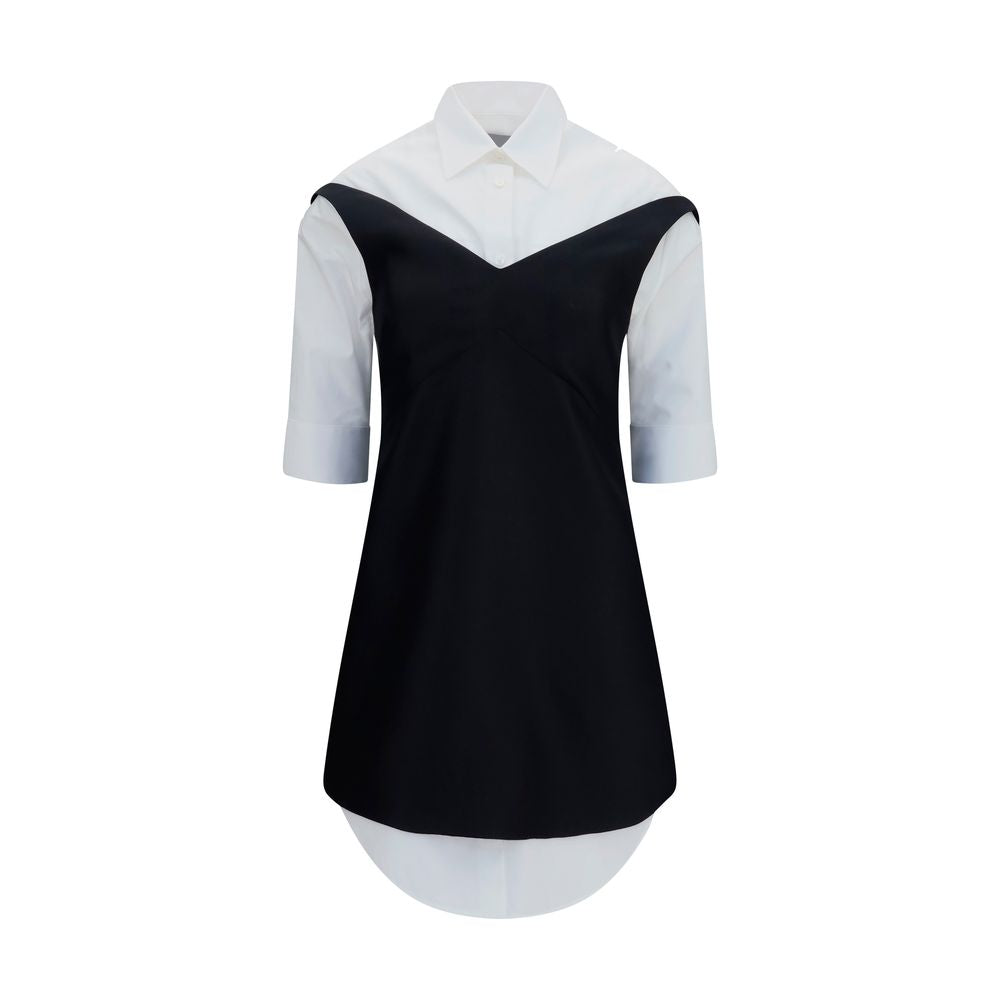 Dress by Balenciaga for women in silk & merino wool black & pearl showcases a striking silhouette, elegantly detailed with a short-sleeve, refined v-neck shirt-collar neckline, and a striking short mini for a striking finish.