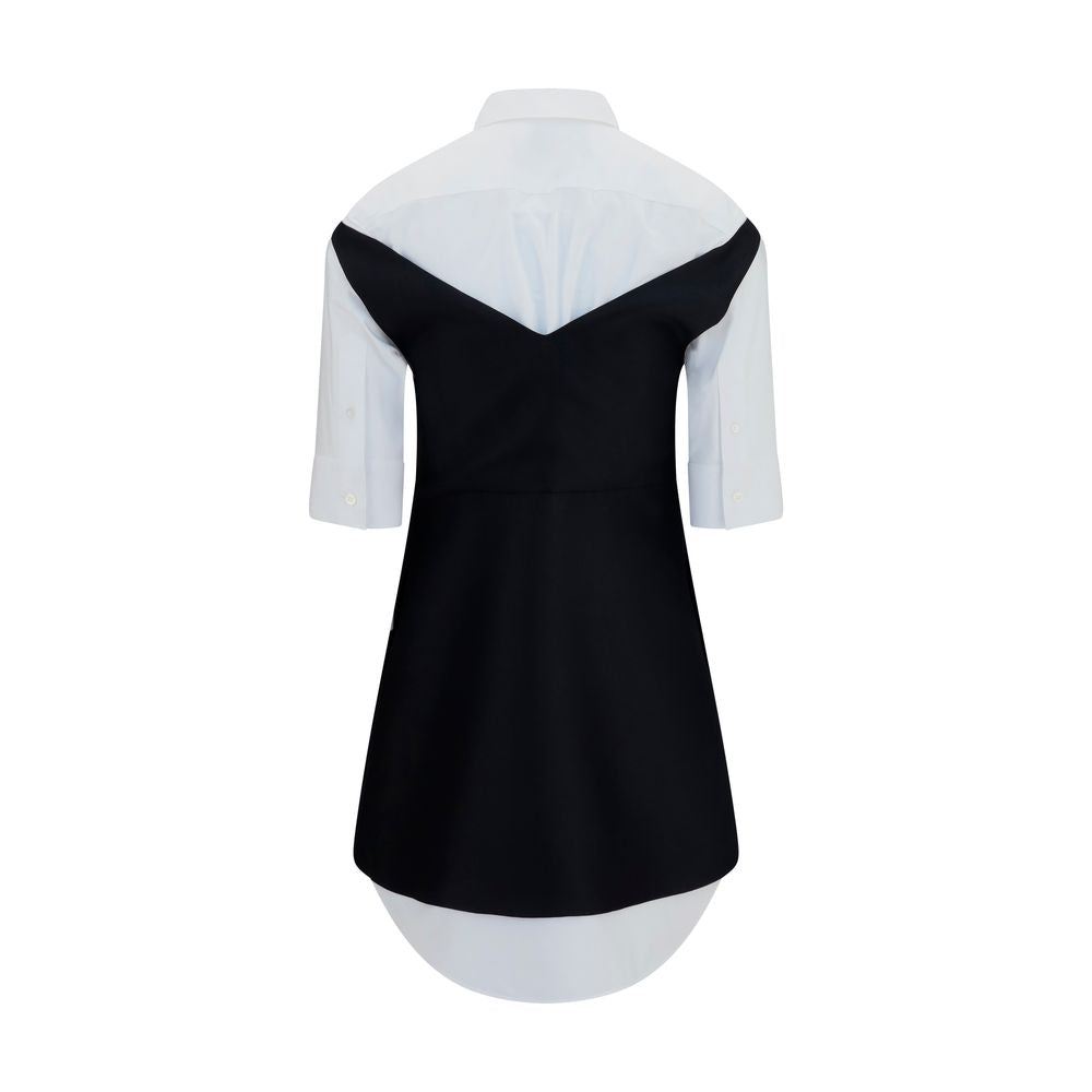 Dress by Balenciaga for women in silk & merino wool black & pearl features an cute silhouette, detailed with a and v-neck shirt-collar neckline that elegantly flows into a cute short mini.