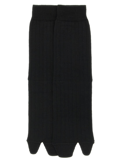 Socks by Maison Margiela for women in polyamide wool black, white & signature features a snug silhouette, artfully capturing the essence of the snug Aren Japanese Women's Polyamide Wool Socks design for a sophisticated look.