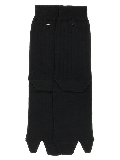 These Socks by Maison Margiela for women in polyamide wool black, white & signature present a utilitarian silhouette from the Aren Japanese Women's Polyamide Wool Socks collection, offering a utilitarian fit and refined aesthetic.