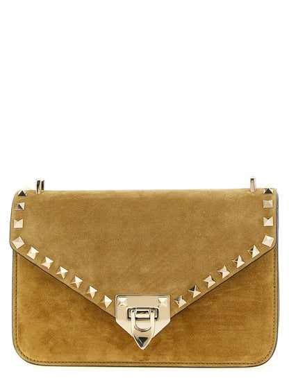 Small 2-in-1 Shoulder & Crossbody Envelope Handbag by Valentino Garavani for women in suede calfskin leather beige, gold & signature features a versatile chic silhouette, meticulously detailed with a secure snap, ample , and versatile crossbody-strap, shoulder-strap & adjustable-strap.
