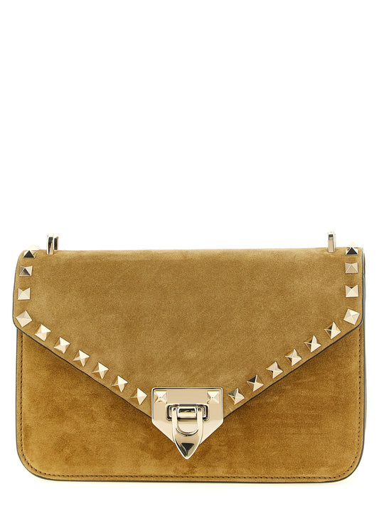Small 2-in-1 Shoulder & Crossbody Envelope Handbag by Valentino Garavani for women in suede calfskin leather beige, gold & signature features a versatile chic silhouette, meticulously detailed with a secure snap, ample , and versatile crossbody-strap, shoulder-strap & adjustable-strap.