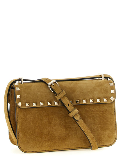 Small 2-in-1 Shoulder & Crossbody Envelope Handbag by Valentino Garavani for women in suede calfskin leather beige, gold & signature features a multifaceted silhouette, showcasing a secure snap and multifaceted with versatile crossbody-strap, shoulder-strap & adjustable-strap for multifaceted style.