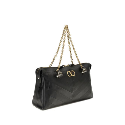 Medium Shoulder Bag by Valentino Garavani for women in nappa & suede leather black, chevron, signature & patchwork showcases a enviable silhouette, artfully detailed with a secure zipper & button, organized , and versatile shoulder-strap, handle & adjustable-strap for a enviable look.