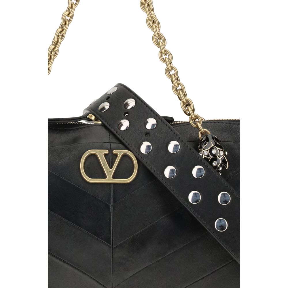 Medium Shoulder Bag by Valentino Garavani for women in nappa & suede leather black, chevron, signature & patchwork presents a versatile silhouette, showcasing a secure zipper & button and versatile with versatile shoulder-strap, handle & adjustable-strap for a sophisticated look.