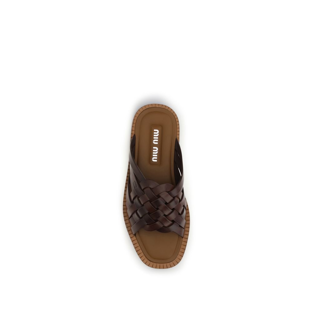 Flat Sandals by Miu Miu for women in bos taurus calf leather brown presents a sculptural silhouette, showcasing the Women's Bos Taurus Calf Leather Flat Sandals design with a sculptural flat and for a premium look.