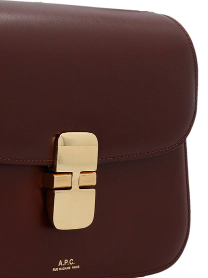 Small 2-in-1 Shoulder & Crossbody Handbag by A.P.C. for women in cowhide leather bordeaux features a versatile chic silhouette, meticulously detailed with a secure snap, ample , and versatile crossbody-strap, shoulder-strap & adjustable-strap.
