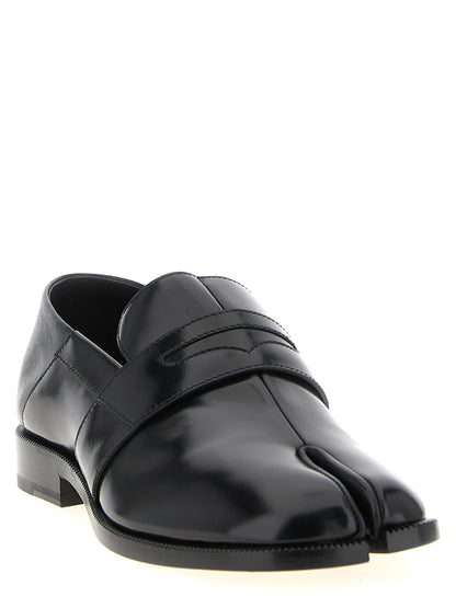 Flat Loafer Slip-On Sock Shoes by Maison Margiela for women in calfskin leather black showcases a resplendent Japanese Women's Calfskin Leather Flat Loafer Slip-On Sock Shoes aesthetic, defined by its resplendent and elegant flat.