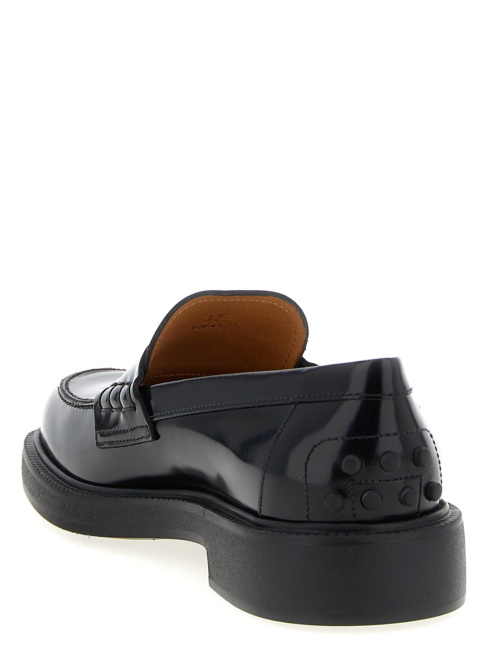 Flat Loafer Slip-On Shoes by Tod's for women in bos taurus calfskin leather gradient & black features an effortless chic silhouette, showcasing the Gommini Women's Bos Taurus Calfskin Leather Flat Loafer Slip-On Shoes design with an effortless chic flat and a for a effortless chic look.