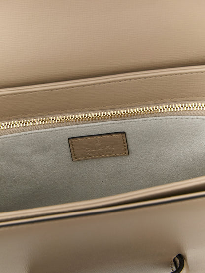 Medium Shoulder Flap Bag by Gucci for women in calfskin leather beige & signature features a effortless sophistication silhouette, secured by a flap with ample and versatile shoulder-strap & adjustable-strap for a effortless sophistication finish.