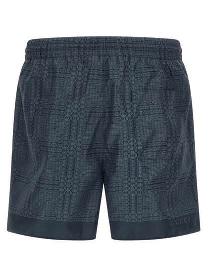 Swim Shorts by Gucci for men in polyester & mesh blue & print features a refined silhouette, showcasing the premium design of this Gg Men's Polyester & Mesh Swim Shorts.