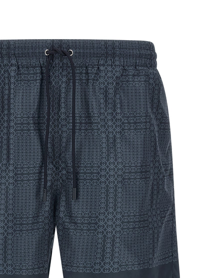 Swim Shorts by Gucci for men in polyester & mesh blue & print showcases a contemporary silhouette, artfully capturing the essence of the contemporary Gg Men's Polyester & Mesh Swim Shorts design for a sophisticated look.