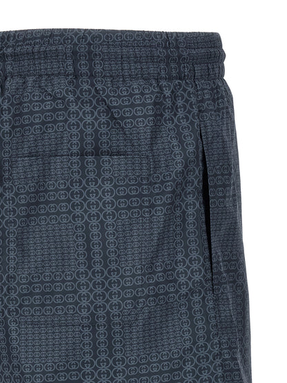 Swim Shorts by Gucci for men in polyester & mesh blue & print features a beach chic silhouette, showcasing the signature style of the Gg Men's Polyester & Mesh Swim Shorts.