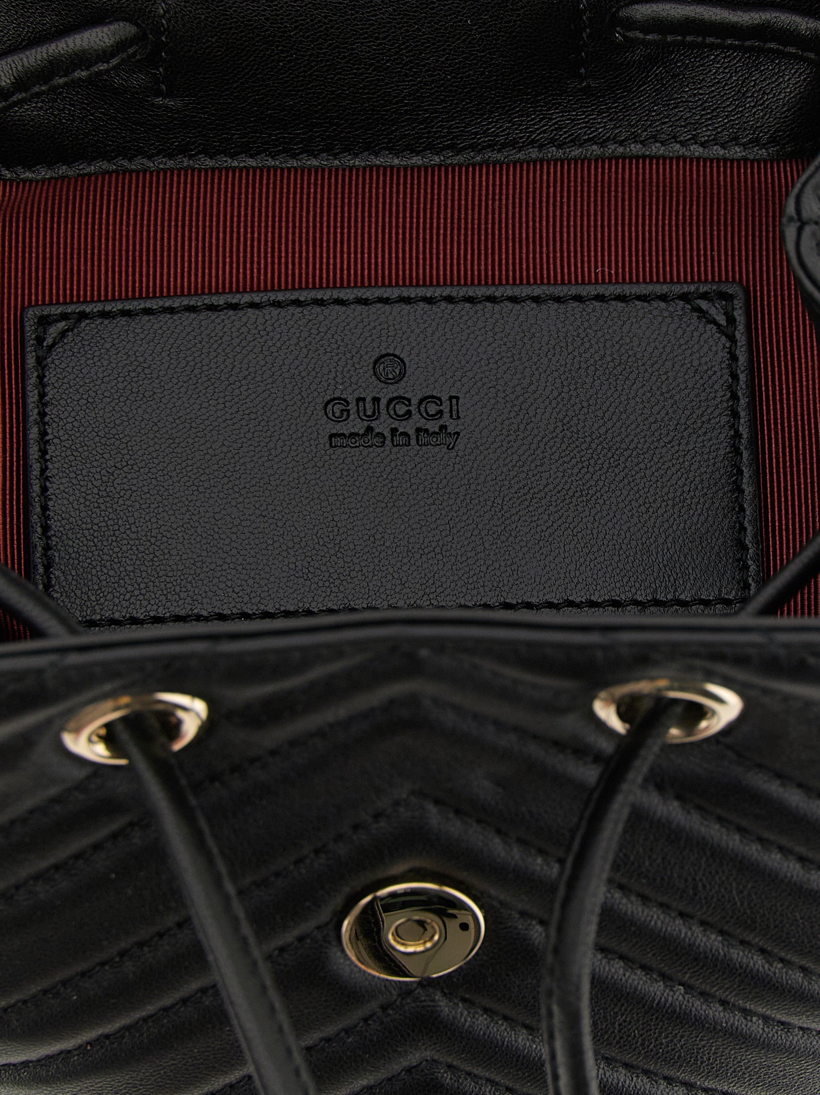 Medium Drawstring Backpack by Gucci for women in viscose & lamb leather black, patterned, chevron & signature features an ultra-portable silhouette from the Gg Marmont Viscose & Lamb Leather Medium Drawstring Backpack range, with a secure flap, drawstring & magnetic, ample , and versatile backpack-strap & adjustable-strap.