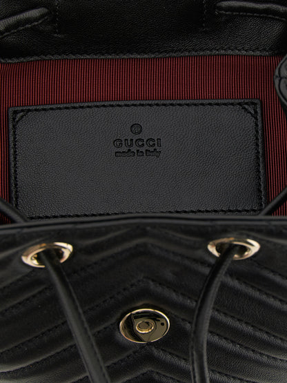 Medium Drawstring Backpack by Gucci for women in viscose & lamb leather black, patterned, chevron & signature features an ultra-portable silhouette from the Gg Marmont Viscose & Lamb Leather Medium Drawstring Backpack range, with a secure flap, drawstring & magnetic, ample , and versatile backpack-strap & adjustable-strap.