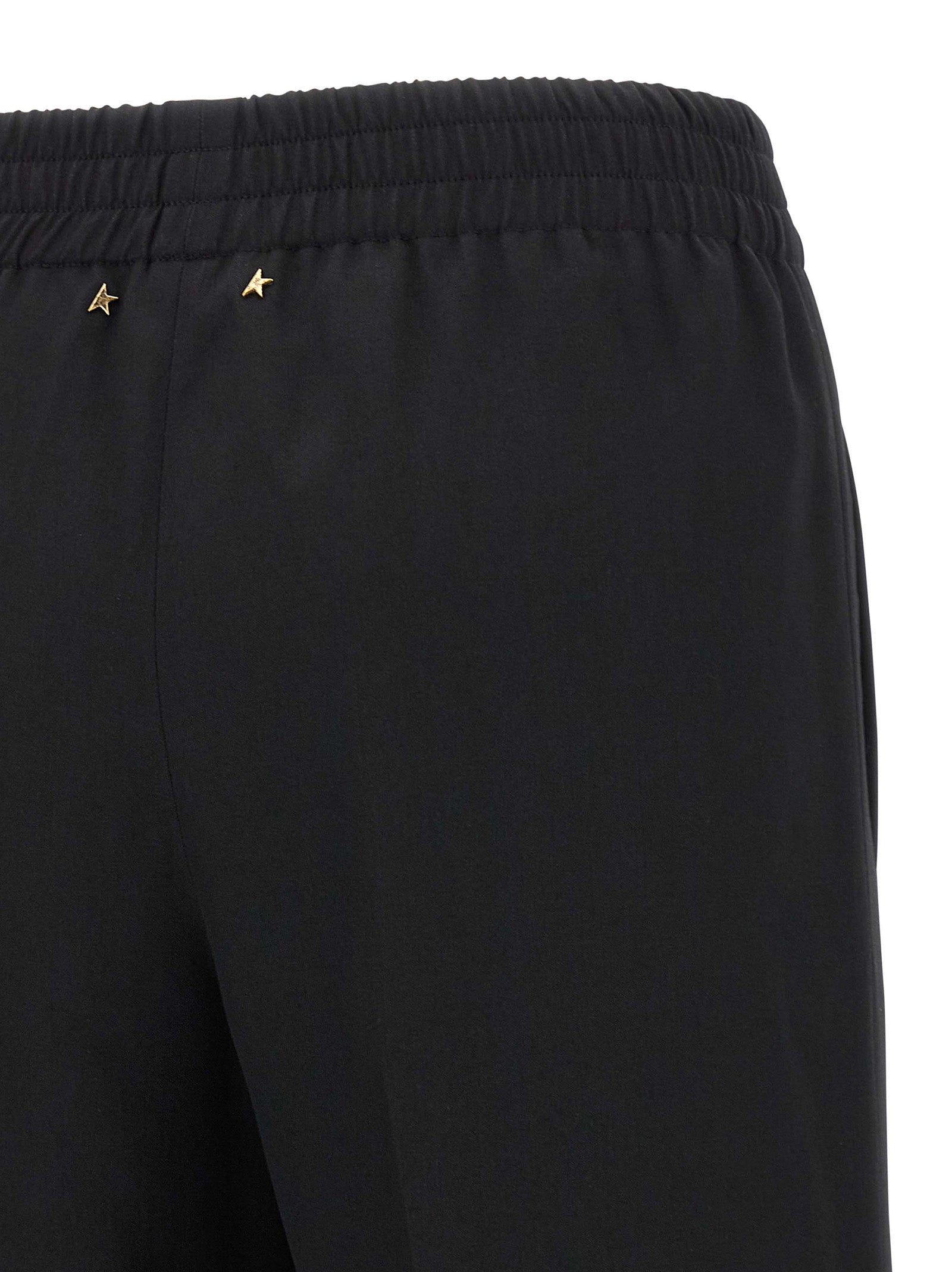 Trousers by Golden Goose for women in virgin wool black presents a perennial silhouette, meticulously tailored with a straight-leg cut, long finish, and an elegant .
