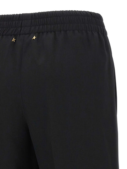 Trousers by Golden Goose for women in virgin wool black presents a perennial silhouette, meticulously tailored with a straight-leg cut, long finish, and an elegant .