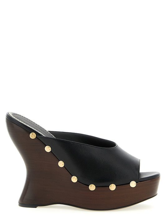 Wedge Mules Sandals by Magda Butrym for women in calfskin leather black features an statuesque Women's Calfskin Leather Wedge Mules Sandals silhouette with a refined wedge and elegant open toe style.