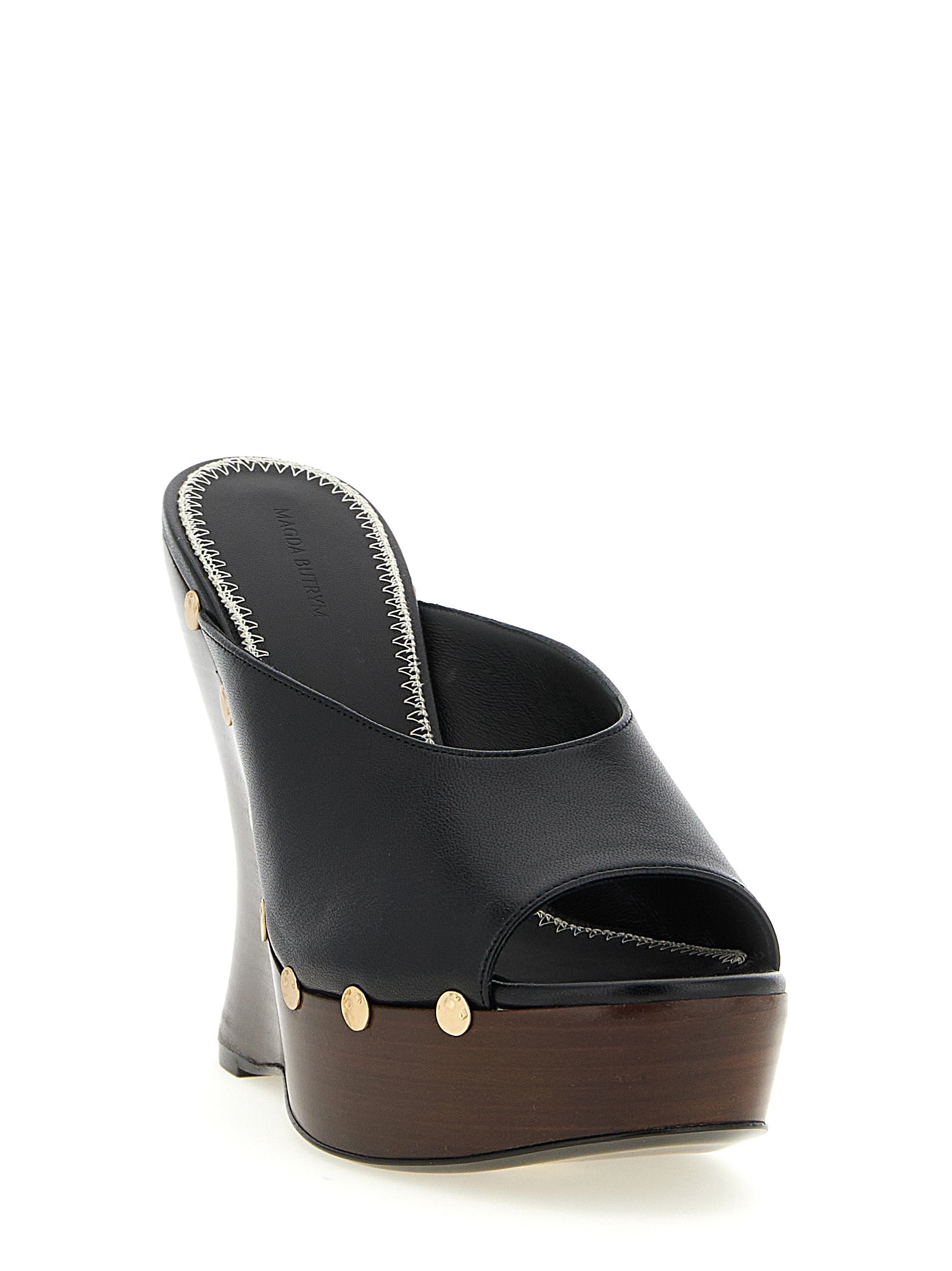 Wedge Mules Sandals by Magda Butrym for women in calfskin leather and black presents a captivating silhouette, showcasing the signature style of the Women's Calfskin Leather Wedge Mules Sandals with a captivating wedge and captivating open toe style.