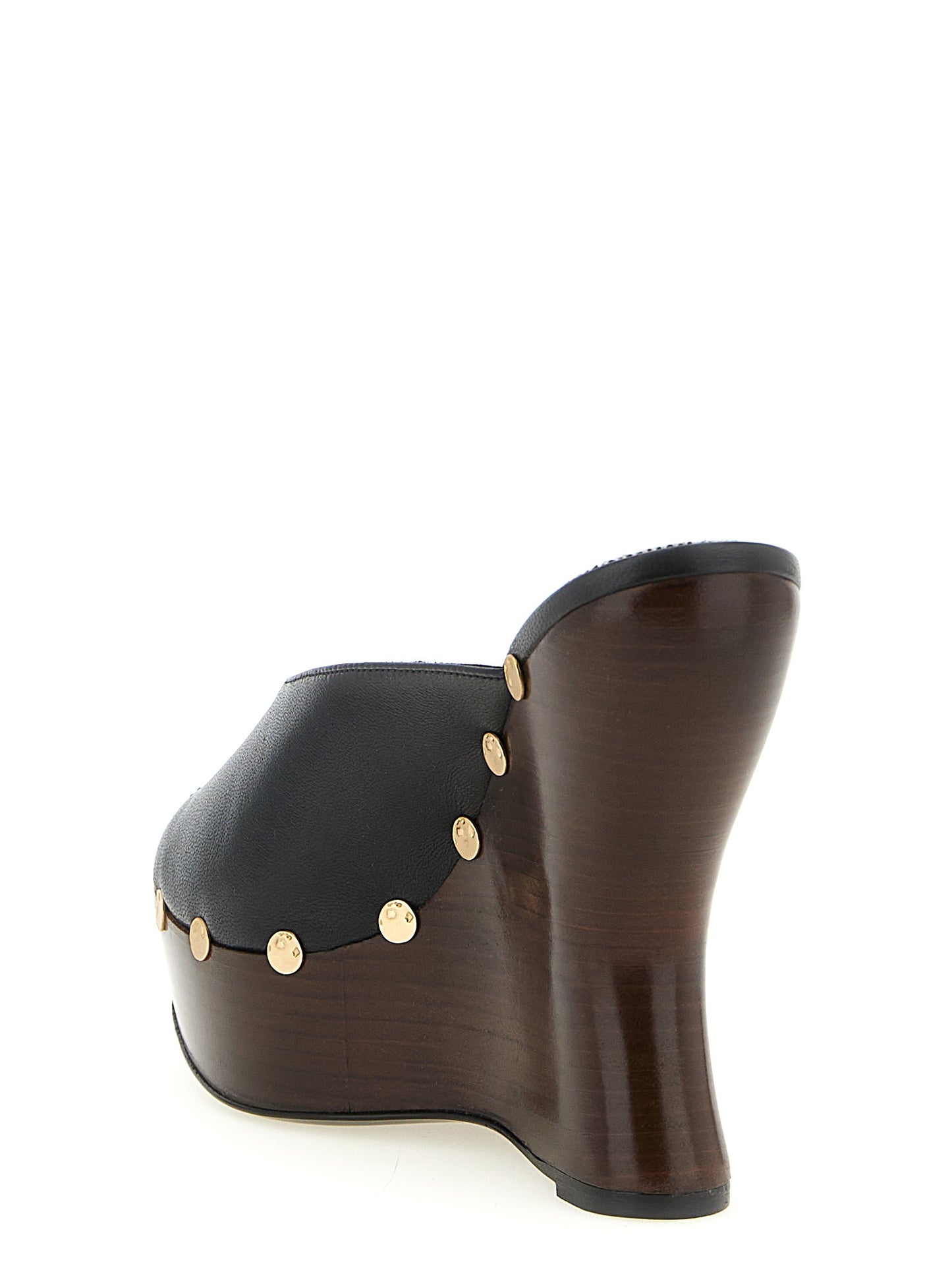 Wedge Mules Sandals by Magda Butrym for women in calfskin leather black features an statuesque Women's Calfskin Leather Wedge Mules Sandals silhouette with a refined wedge and elegant open toe style.
